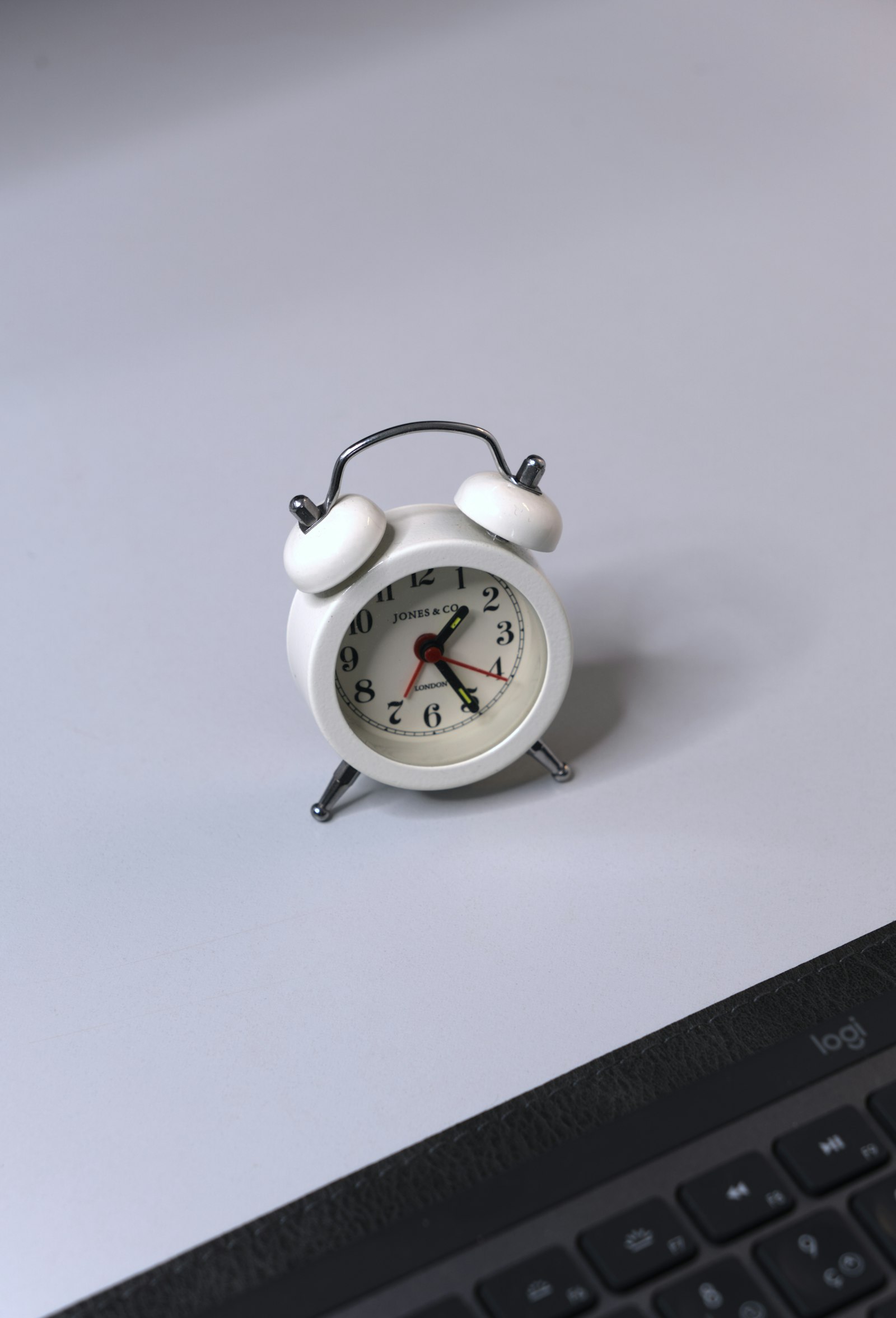 Alarm clock on top of a laptop, symbolizing time-critical response to a cybersecurity incident
