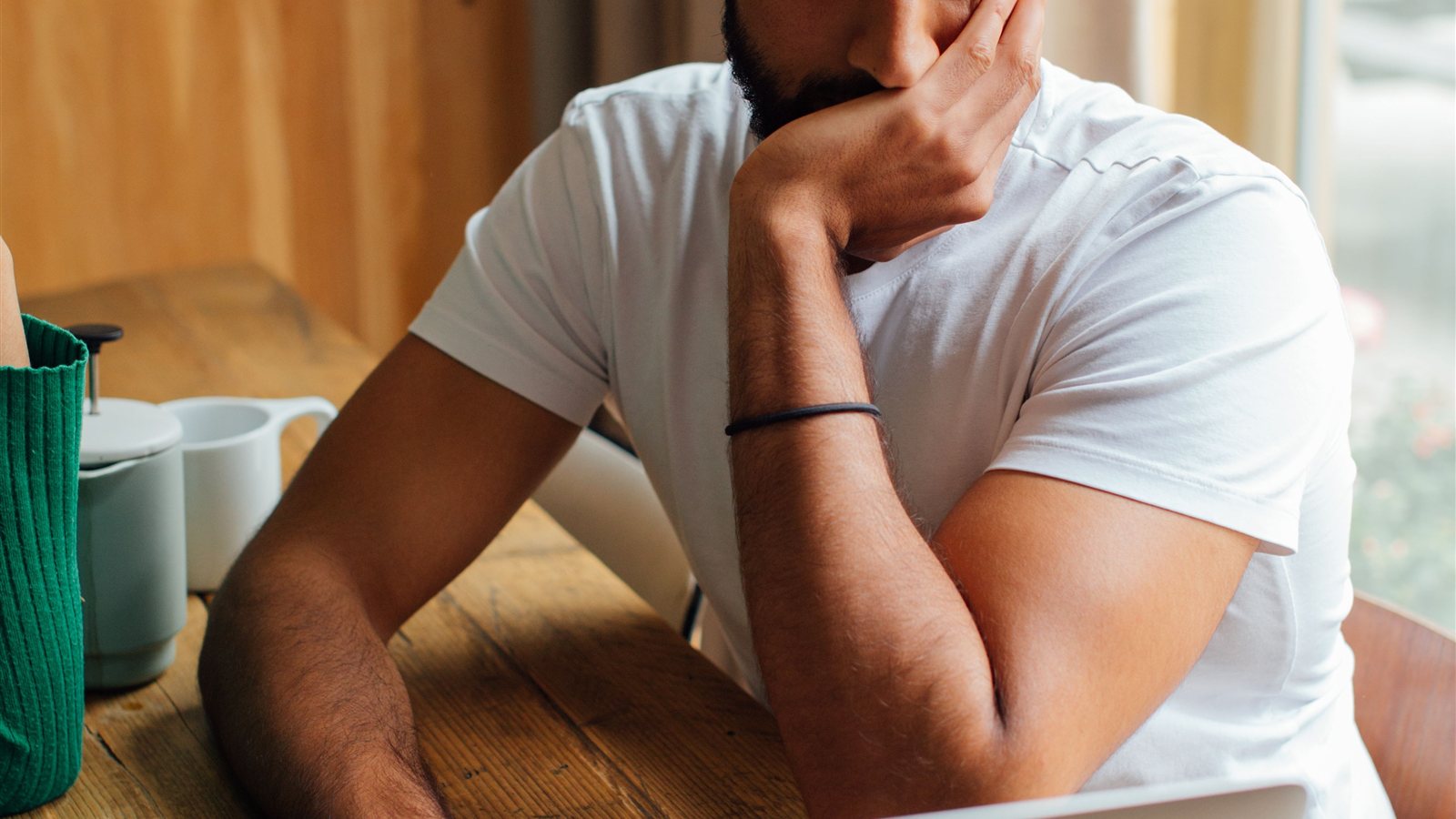 Man thoughtfully reviewing an email on his laptop before deciding whether to trust an unsubscribe link