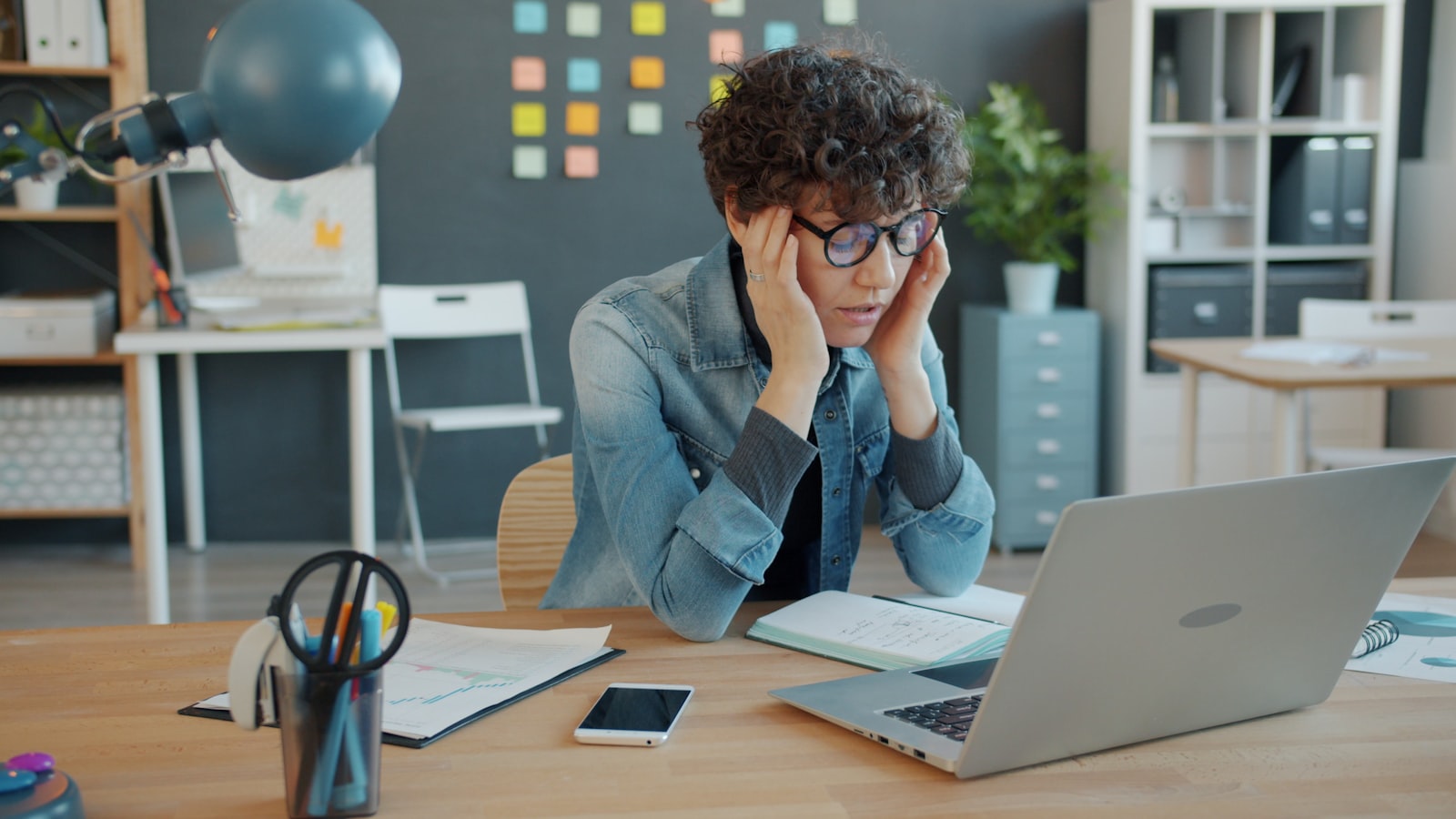 Person looking concerned while reviewing an email on a laptop, representing a phishing attempt