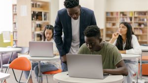 Students using laptops in a classroom, representing back-to-school technology and cybersecurity