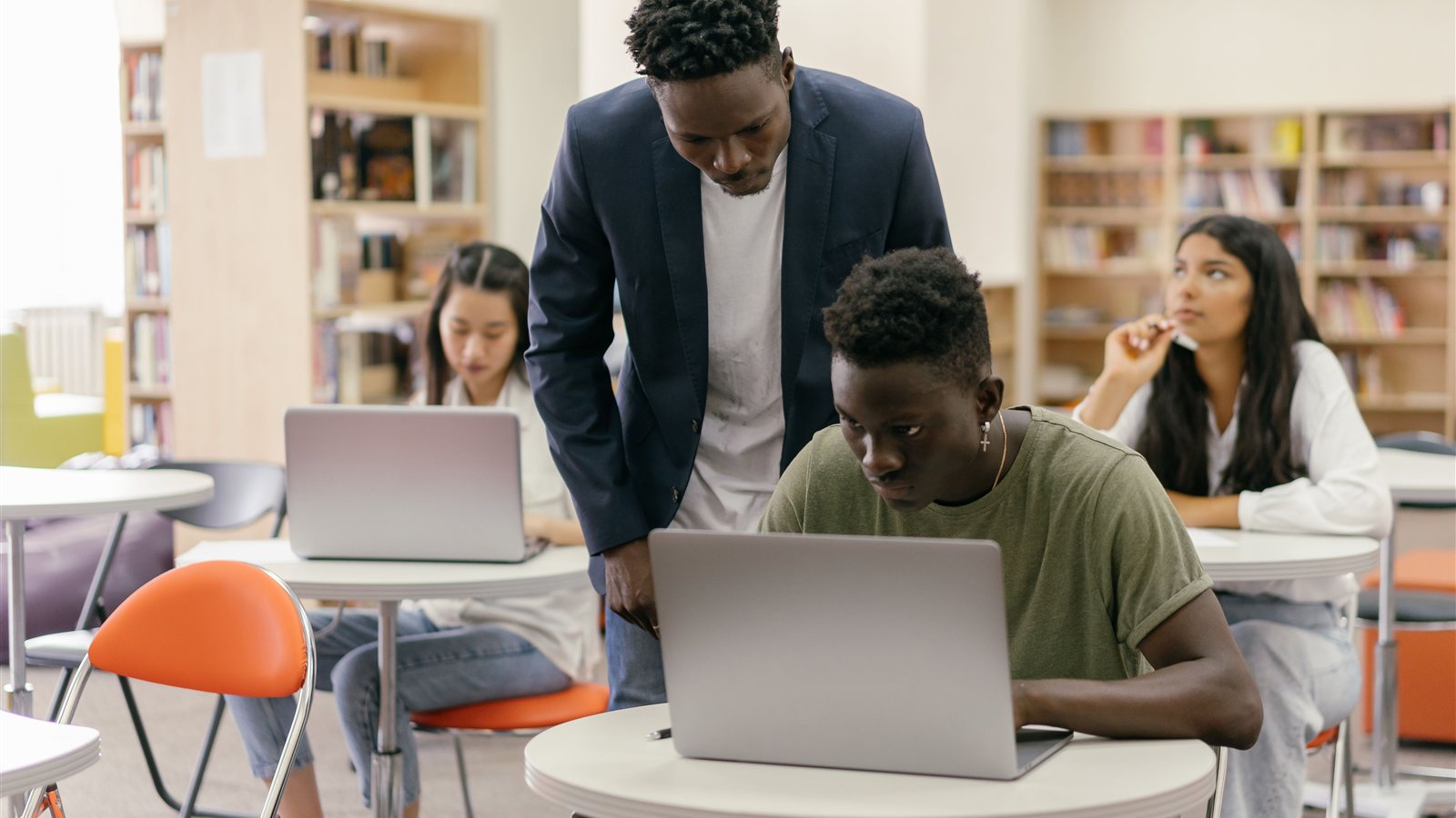 Students using laptops in a classroom, representing back-to-school technology and cybersecurity